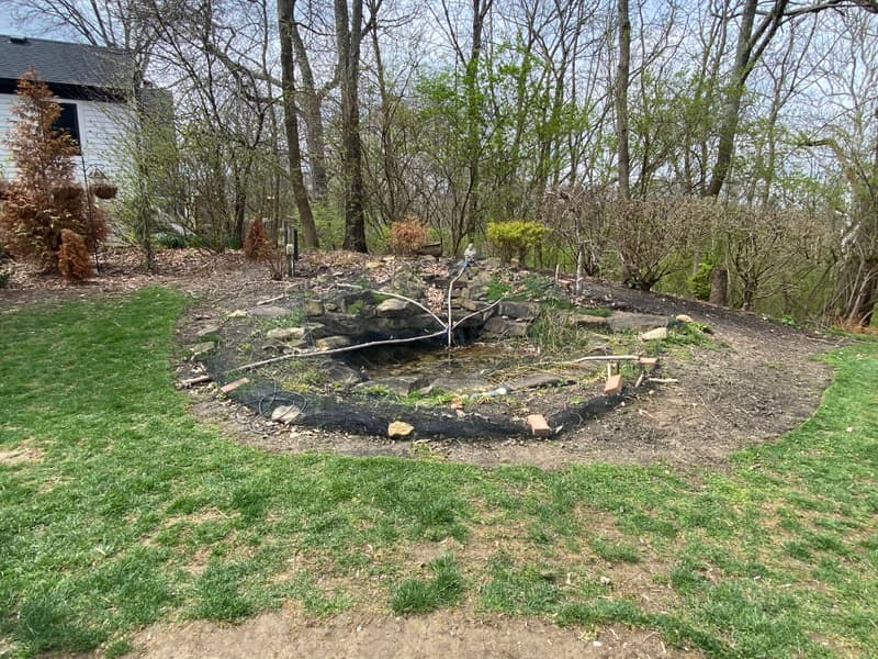 New backyard bed with edging, stone and mulch